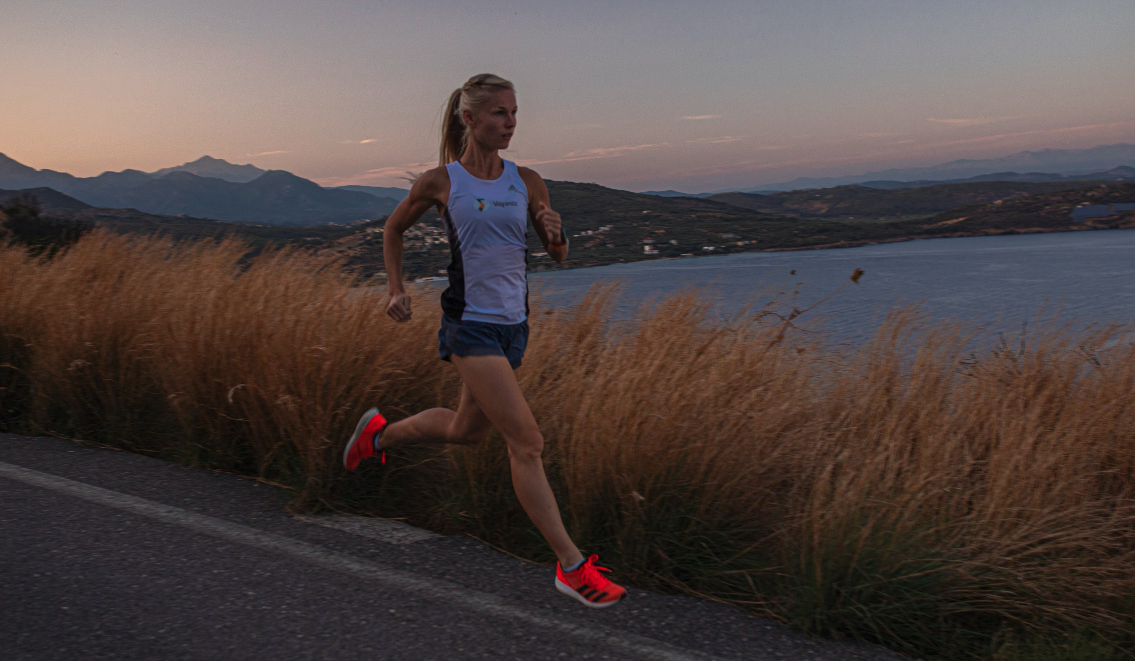 Ultrarunner Noora Honkla, running at sunset.
