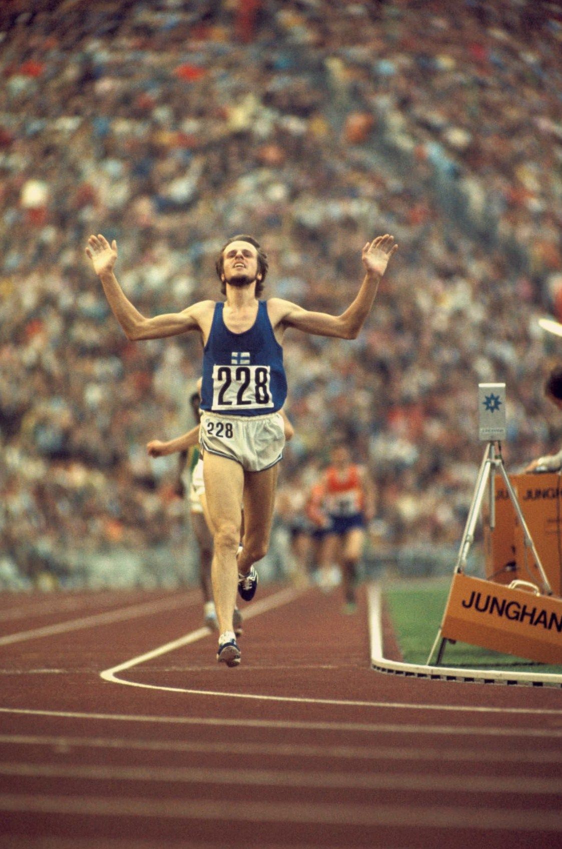 Finnish long distance runner, Lasse Viren, running on a track.